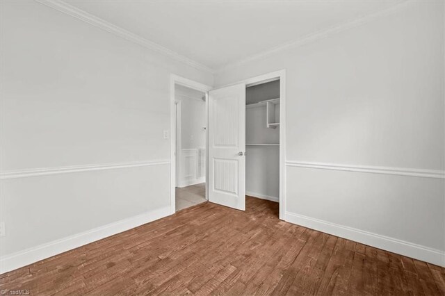 3523 Riverside Dr, Greensboro, NC 27406 - unfurnished bedroom with a closet, ornamental molding, baseboards, and wood finished floors
