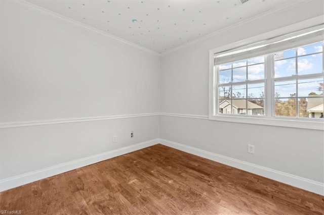 3523 Riverside Dr, Greensboro, NC 27406 - spare room featuring baseboards, wood finished floors, and ornamental molding