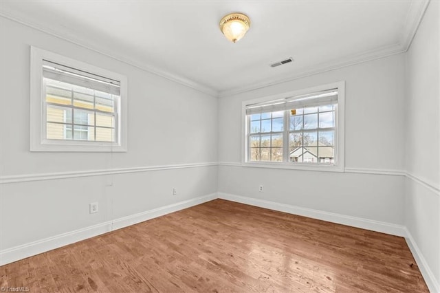 3523 Riverside Dr, Greensboro, NC 27406 - unfurnished room with baseboards, visible vents, ornamental molding, and wood finished floors