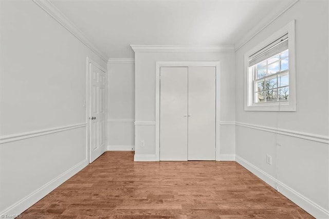3523 Riverside Dr, Greensboro, NC 27406 - unfurnished bedroom featuring baseboards, a closet, crown molding, and wood finished floors