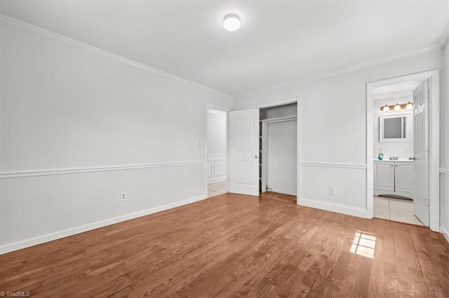 3523 Riverside Dr, Greensboro, NC 27406 - unfurnished bedroom with a closet, ensuite bath, ornamental molding, and wood finished floors