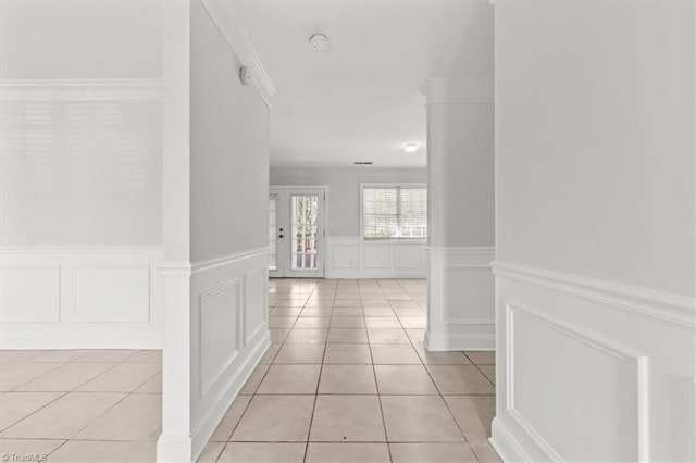 3523 Riverside Dr, Greensboro, NC 27406 - hall featuring a decorative wall, light tile patterned floors, a wainscoted wall, and crown molding