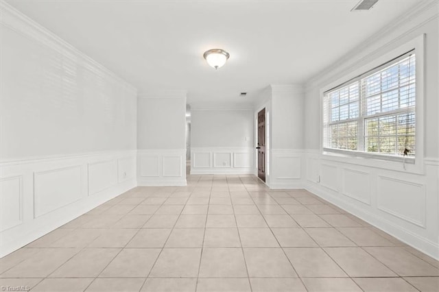 3523 Riverside Dr, Greensboro, NC 27406 - unfurnished room featuring visible vents, a decorative wall, crown molding, and light tile patterned floors