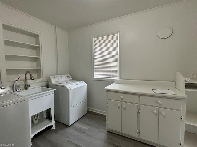 laundry room featuring cabinets, independent washer and dryer, hardwood / wood-style flooring, and ornamental molding