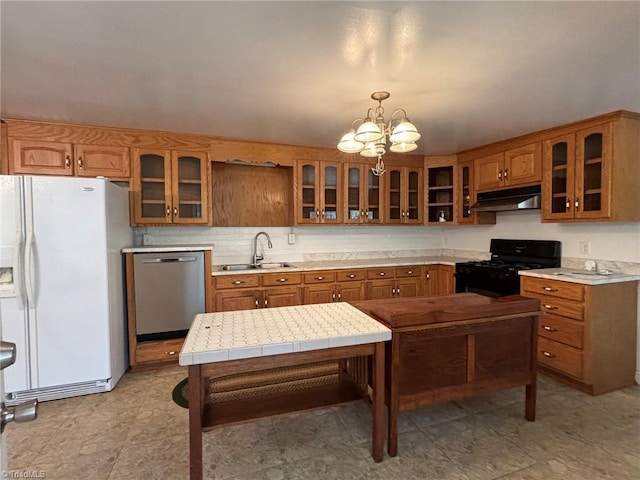 kitchen with white refrigerator with ice dispenser, decorative light fixtures, black range with gas cooktop, a notable chandelier, and dishwasher