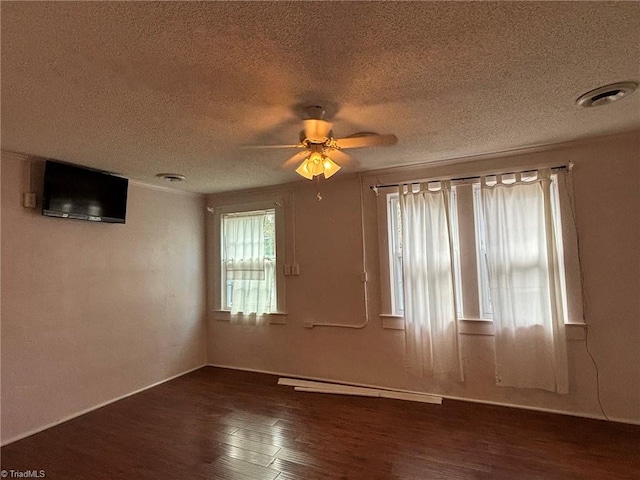 spare room featuring a textured ceiling, dark hardwood / wood-style flooring, and ceiling fan