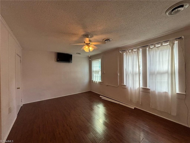 empty room featuring a baseboard heating unit, dark hardwood / wood-style flooring, a textured ceiling, and ceiling fan