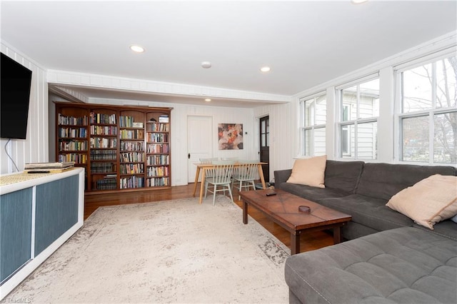 living room with a wealth of natural light, recessed lighting, and wood finished floors