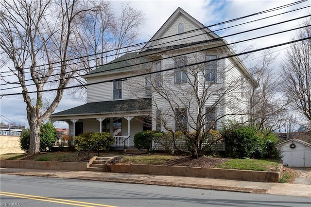 view of front of house with a porch and an outdoor structure