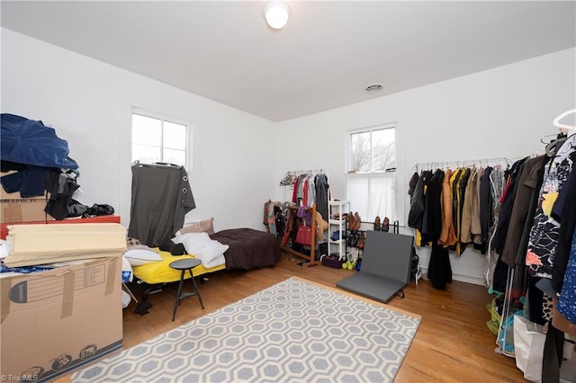 bedroom featuring visible vents and wood finished floors