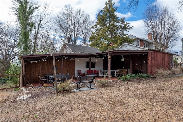 back of property featuring a chimney and a patio area