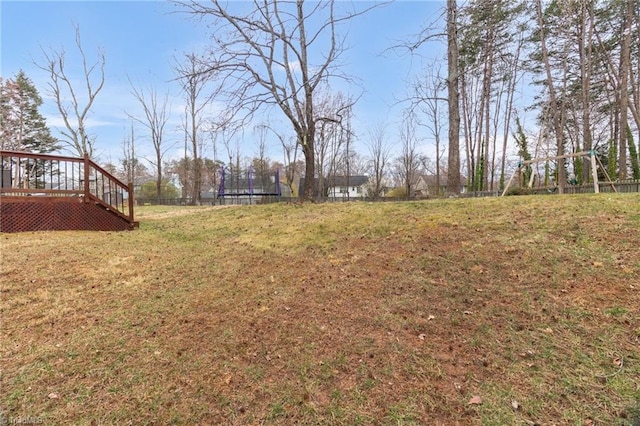 view of yard with a deck and fence