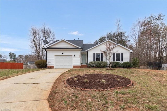 ranch-style home with fence, concrete driveway, a front lawn, a garage, and a trampoline