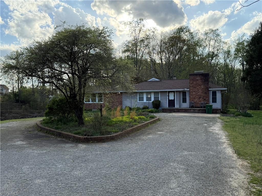 1980 Turkey Ln, Pfafftown, NC 27040 - ranch-style house with gravel driveway and a chimney
