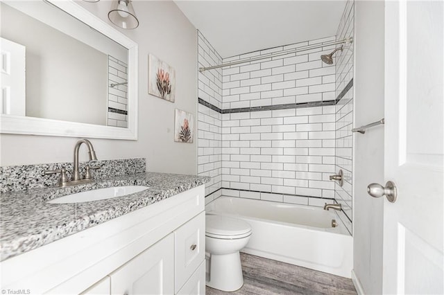 full bath with vanity, bathing tub / shower combination, toilet, and wood finished floors