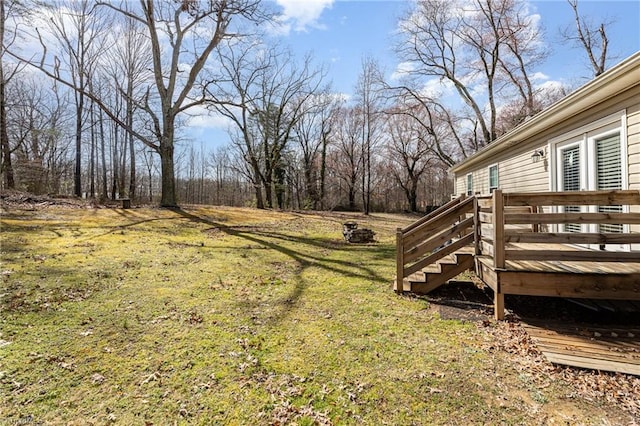 view of yard with a fire pit and a deck