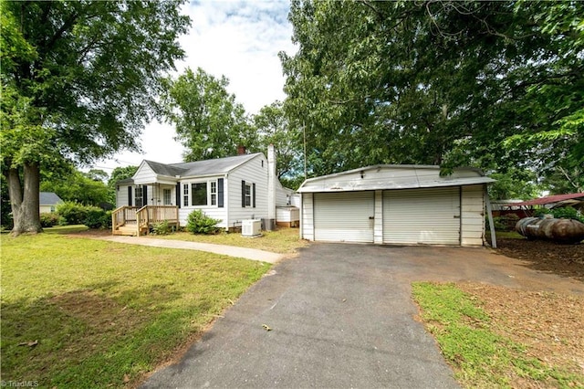 4065 Leo St, Winston-Salem, NC 27105 - view of front of home with a front lawn, a garage, an outbuilding, cooling unit, and a chimney