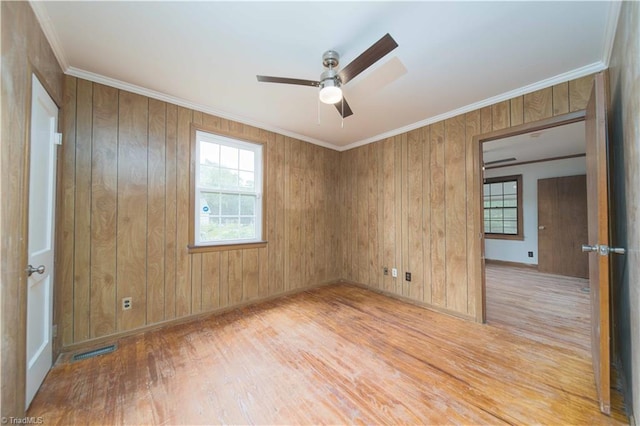 4065 Leo St, Winston-Salem, NC 27105 - unfurnished room featuring wood finished floors, ceiling fan, ornamental molding, baseboards, and wooden walls