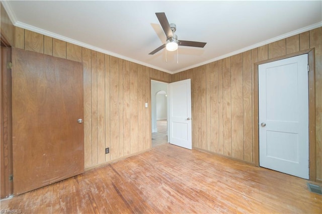 4065 Leo St, Winston-Salem, NC 27105 - unfurnished bedroom with wood finished floors, crown molding, wooden walls, and ceiling fan