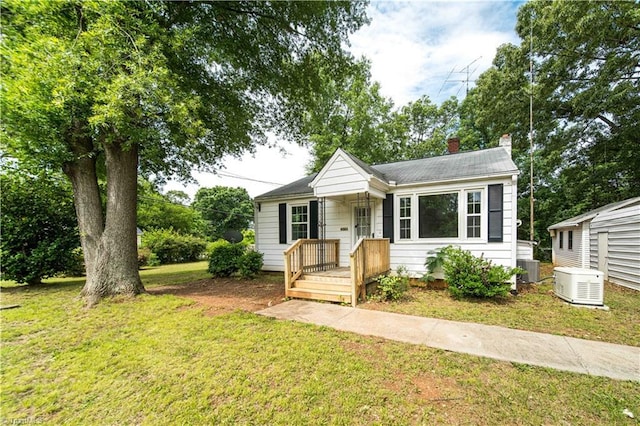 4065 Leo St, Winston-Salem, NC 27105 - view of front facade featuring a chimney, a front lawn, and central air condition unit