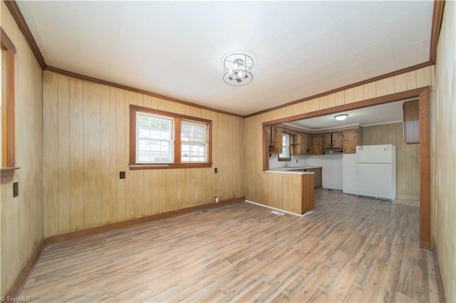 4065 Leo St, Winston-Salem, NC 27105 - kitchen with freestanding refrigerator, light wood finished floors, a peninsula, brown cabinetry, and crown molding
