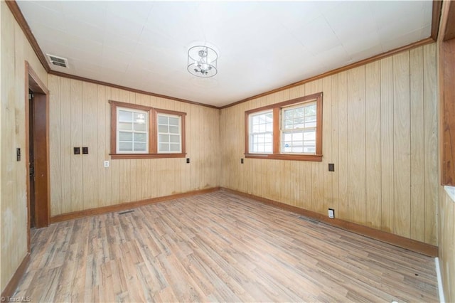 4065 Leo St, Winston-Salem, NC 27105 - spare room with light wood finished floors, baseboards, wooden walls, and ornamental molding