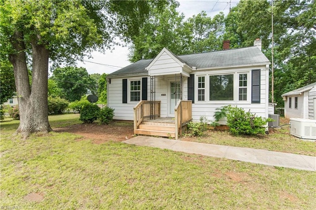 4065 Leo St, Winston-Salem, NC 27105 - view of front facade featuring a chimney, a front yard, and central air condition unit