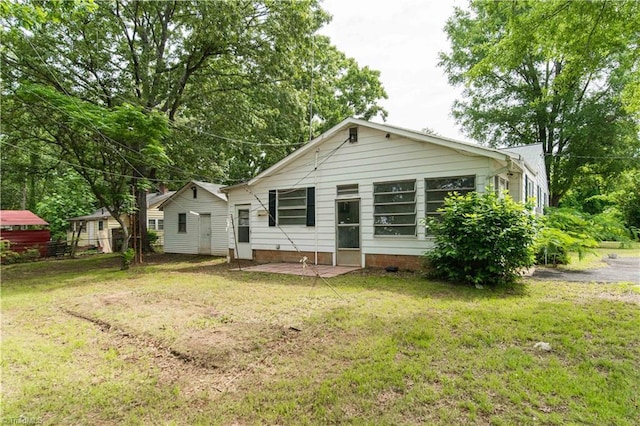 4065 Leo St, Winston-Salem, NC 27105 - back of property with a lawn and a patio