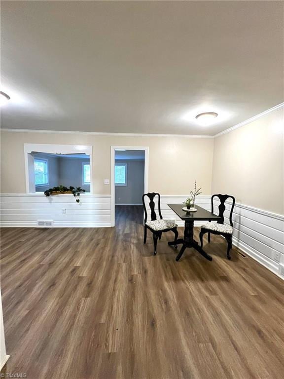 living area with dark hardwood / wood-style flooring and crown molding