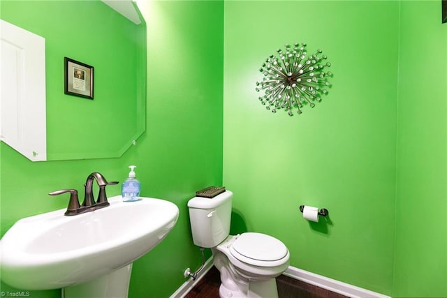 2711 Chari Park Ln, Walkertown, NC 27051 - half bath with a sink, baseboards, toilet, and wood finished floors