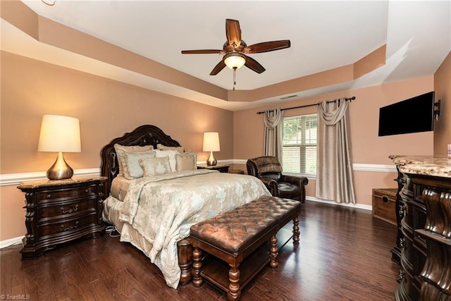 2711 Chari Park Ln, Walkertown, NC 27051 - bedroom with a tray ceiling, dark wood-style flooring, baseboards, and a ceiling fan