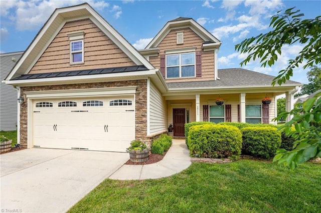 2711 Chari Park Ln, Walkertown, NC 27051 - view of front of house featuring concrete driveway, stone siding, a front lawn, a shingled roof, and an attached garage