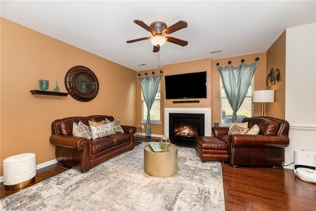 2711 Chari Park Ln, Walkertown, NC 27051 - living area featuring ceiling fan, wood finished floors, a glass covered fireplace, and baseboards