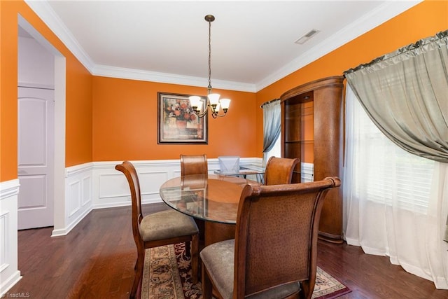 2711 Chari Park Ln, Walkertown, NC 27051 - dining space with dark wood finished floors, a chandelier, crown molding, and a wainscoted wall
