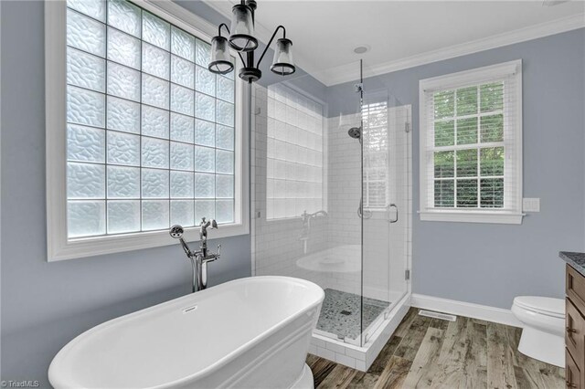 bathroom featuring vanity, wood-type flooring, an inviting chandelier, crown molding, and toilet