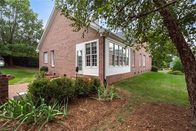 kitchen featuring white cabinets, ornamental molding, appliances with stainless steel finishes, and light hardwood / wood-style floors