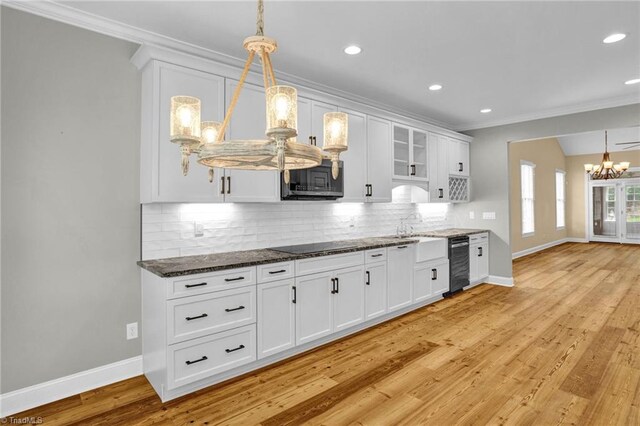 kitchen featuring ceiling fan, ornamental molding, white cabinetry, stainless steel appliances, and light hardwood / wood-style floors