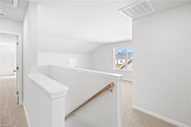 stairway featuring vaulted ceiling and carpet flooring