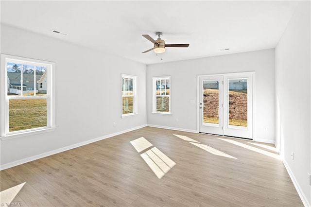 spare room featuring ceiling fan and light wood-type flooring