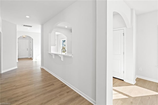 hallway with light hardwood / wood-style flooring