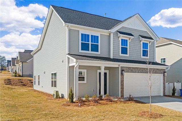 view of front of property featuring a garage and a front lawn