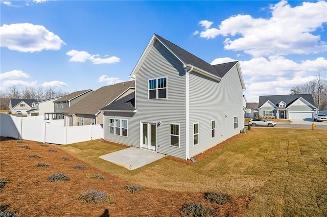 back of house featuring a yard and a patio