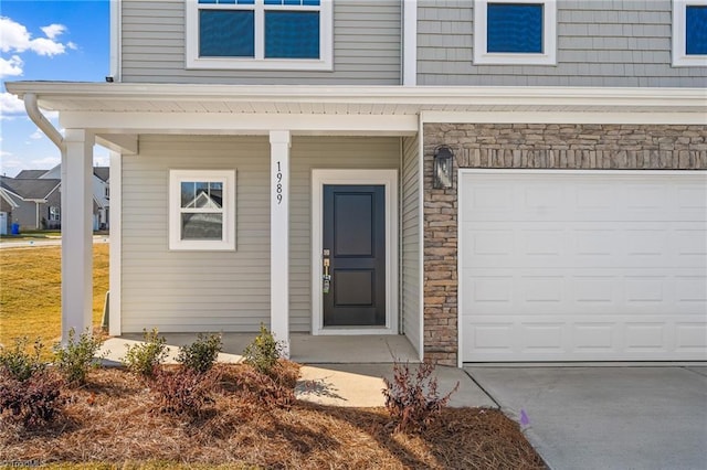 entrance to property with a garage and covered porch