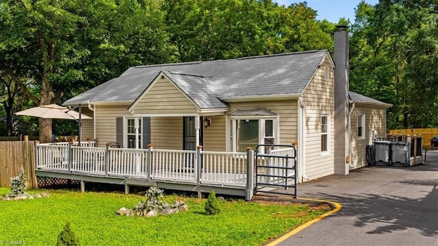 1449 NC Highway 150 W, Summerfield, NC 27358 - view of front of home featuring a chimney, a shingled roof, driveway, and a wooden deck
