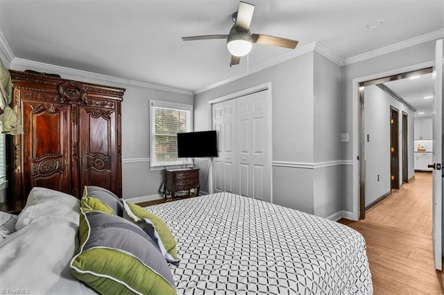 1449 NC Highway 150 W, Summerfield, NC 27358 - bedroom with ornamental molding, wood finished floors, a closet, and ceiling fan