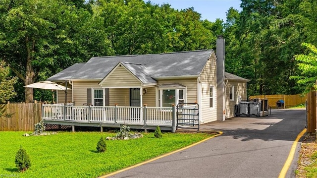 1449 NC Highway 150 W, Summerfield, NC 27358 - view of front of property with a chimney, asphalt driveway, a shingled roof, and covered porch