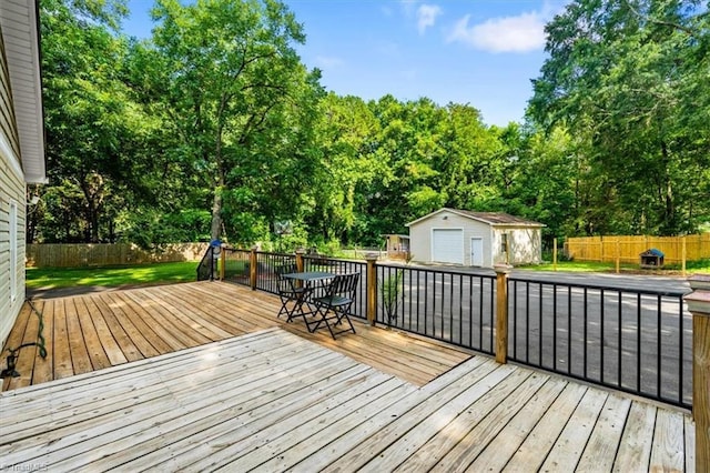 1449 NC Highway 150 W, Summerfield, NC 27358 - wooden deck with a fenced backyard, an outbuilding, a garage, and view of wooded area
