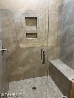 bathroom with a shower with shower door