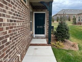 entrance to property with a yard