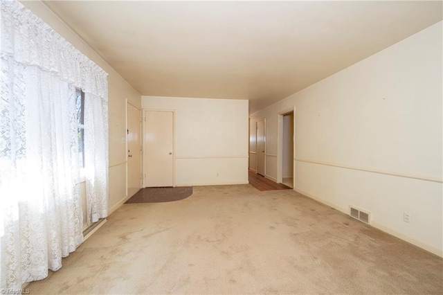 empty room with light carpet and visible vents